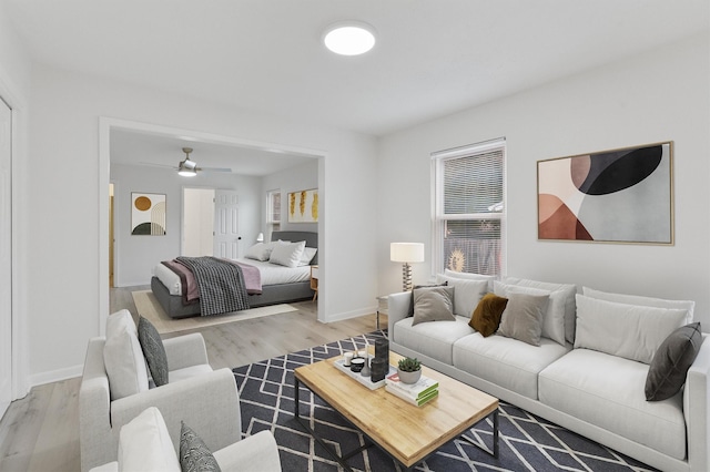 living room featuring light wood-type flooring and ceiling fan