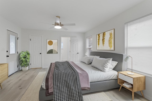 bedroom with ceiling fan and light hardwood / wood-style floors