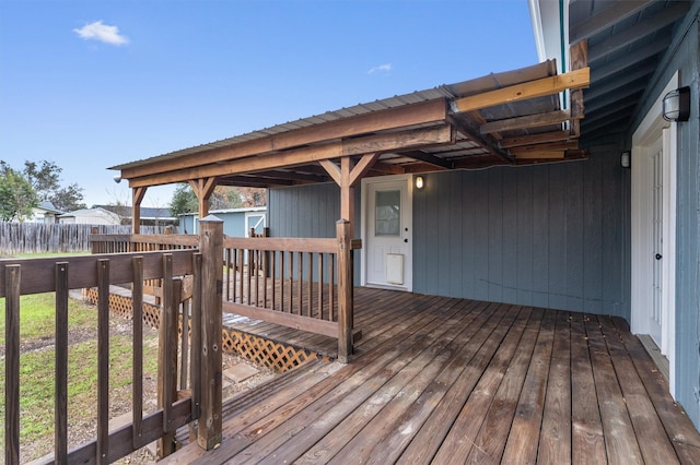 wooden terrace featuring a storage shed