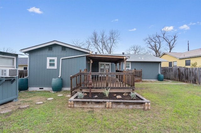 back of house featuring a yard and a wooden deck