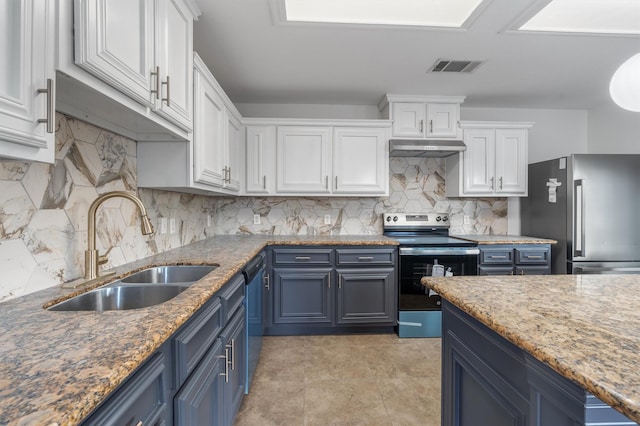 kitchen with sink, white cabinetry, blue cabinetry, and appliances with stainless steel finishes