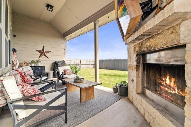 view of patio with an outdoor stone fireplace