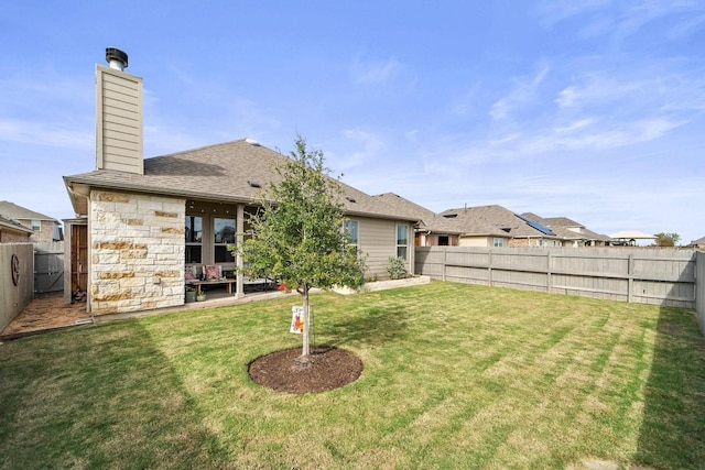 rear view of property with a lawn