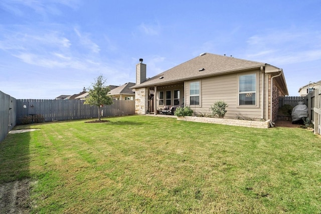 rear view of house featuring a lawn