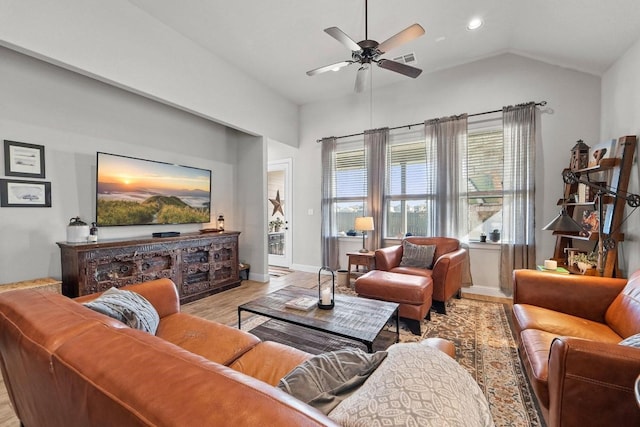 living room with light hardwood / wood-style floors, ceiling fan, and vaulted ceiling