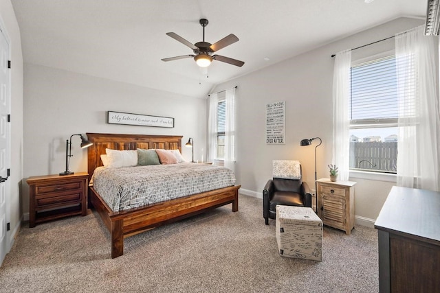 bedroom with vaulted ceiling, ceiling fan, light colored carpet, and multiple windows