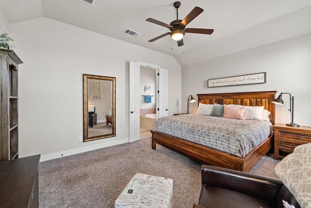 carpeted bedroom with vaulted ceiling, ceiling fan, and ensuite bath