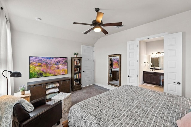 bedroom featuring ceiling fan, ensuite bath, and carpet