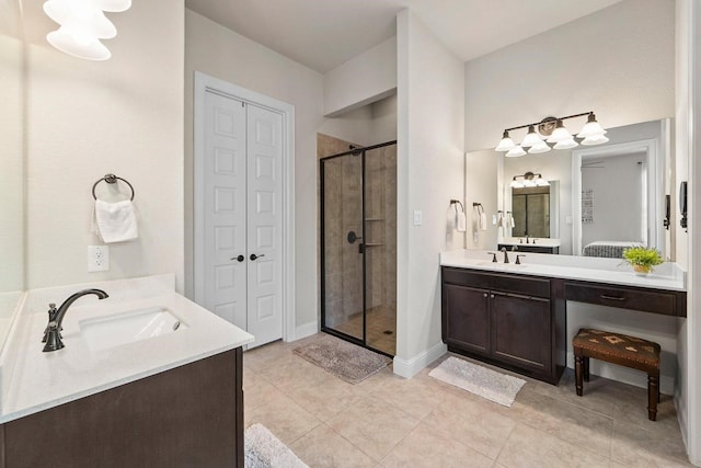 bathroom with tile patterned floors, vanity, and walk in shower