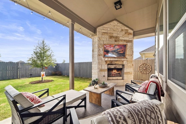 view of patio / terrace with an outdoor living space with a fireplace