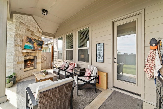 view of patio with an outdoor living space with a fireplace