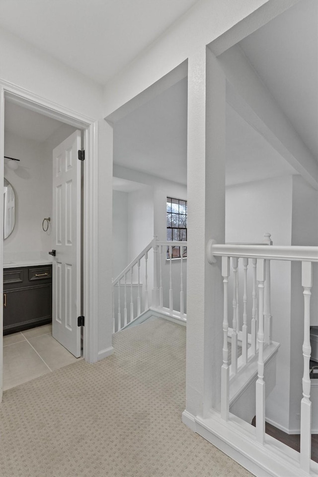 hallway with light colored carpet