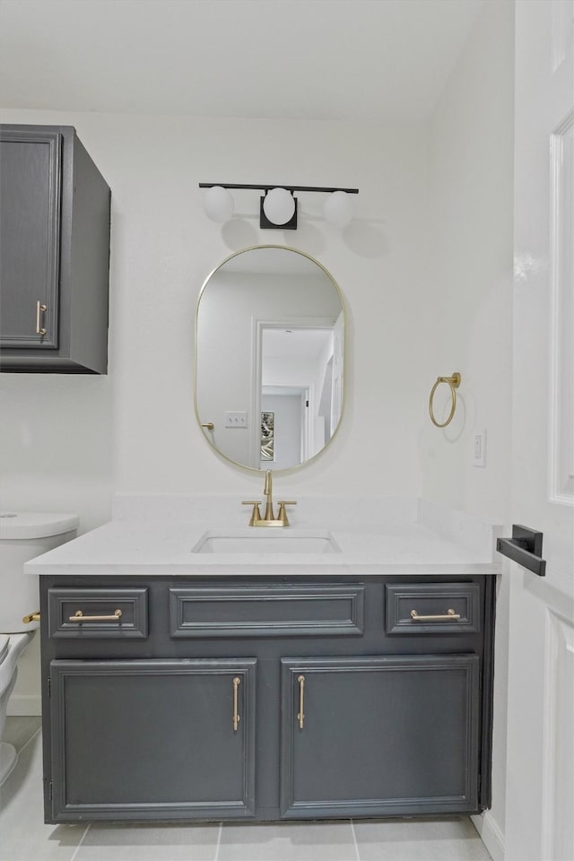 bathroom featuring toilet, vanity, and tile patterned flooring