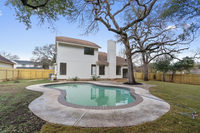 back of house with a lawn, a fenced in pool, and a patio