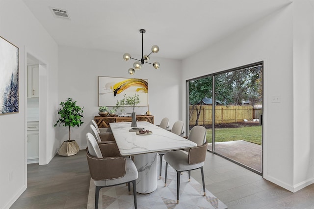 dining room with a notable chandelier and light hardwood / wood-style flooring