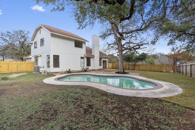 exterior space with a patio area, central AC, a lawn, and a fenced in pool