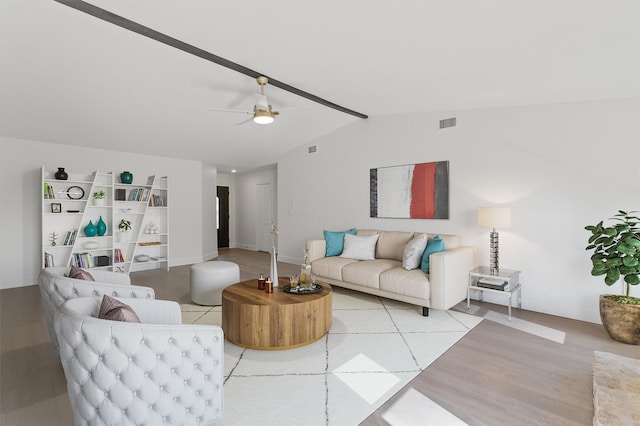 living room featuring hardwood / wood-style flooring, ceiling fan, and vaulted ceiling