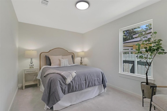 carpeted bedroom with visible vents and baseboards