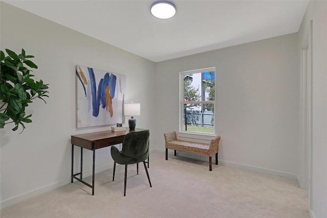 home office with baseboards and light colored carpet