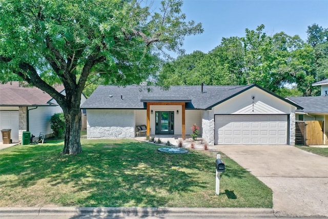 mid-century modern home with a garage, concrete driveway, stone siding, and a front lawn