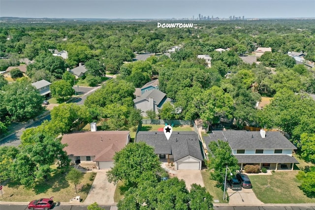 aerial view featuring a forest view and a residential view