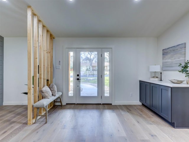 foyer featuring light wood-type flooring and baseboards