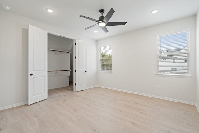 unfurnished bedroom featuring ceiling fan, light hardwood / wood-style floors, and a closet