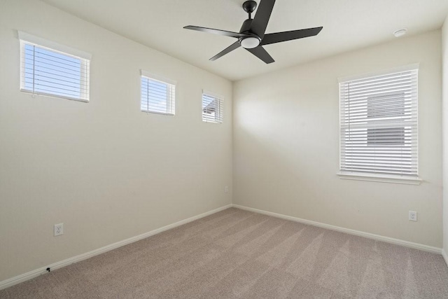 carpeted empty room featuring ceiling fan