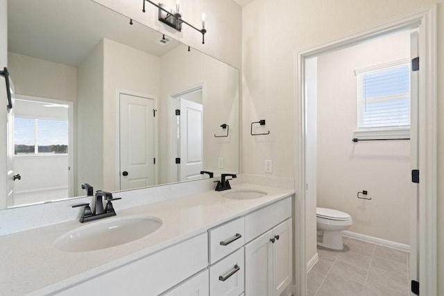 bathroom featuring vanity, tile patterned floors, and toilet