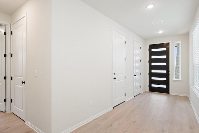 foyer featuring a wealth of natural light and light hardwood / wood-style flooring