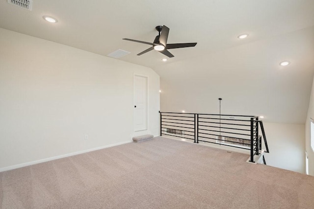 unfurnished room with lofted ceiling, ceiling fan, and carpet