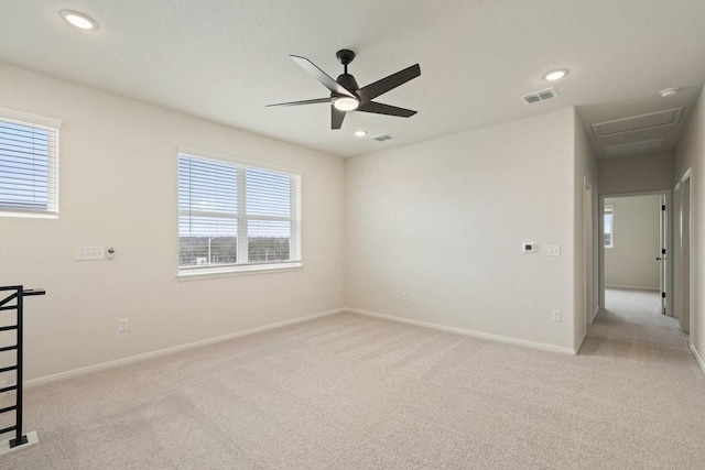 carpeted spare room featuring ceiling fan