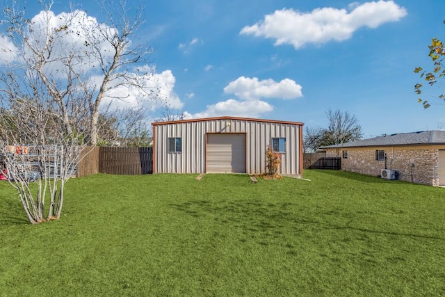 view of yard featuring a garage and an outbuilding