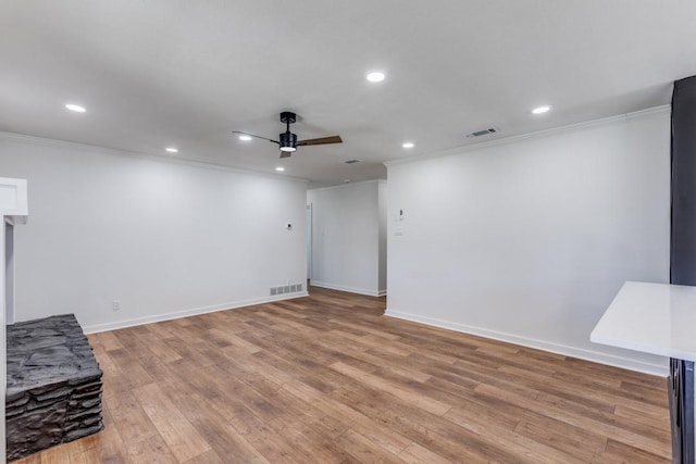 interior space featuring light wood-type flooring, ceiling fan, and crown molding