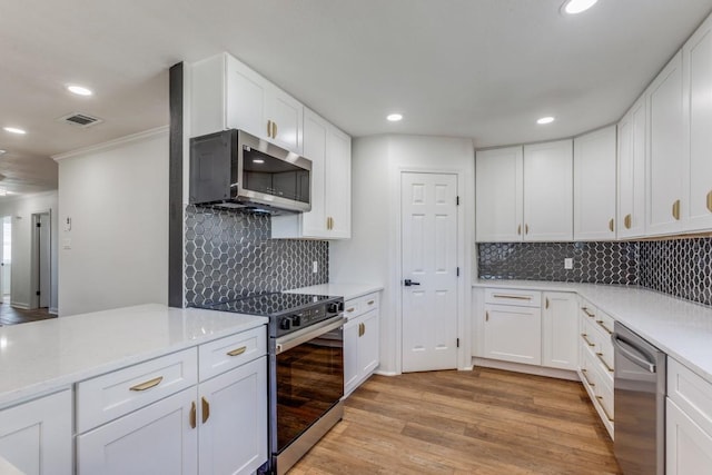 kitchen with stainless steel appliances, light wood-type flooring, light stone counters, decorative backsplash, and white cabinets