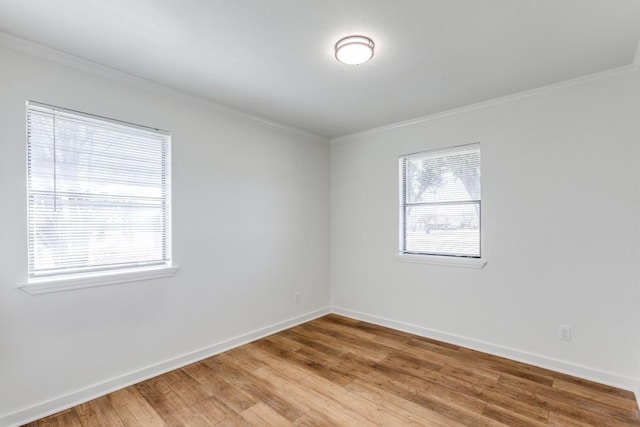 unfurnished room with ornamental molding and wood-type flooring