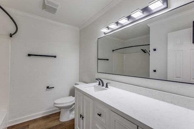 bathroom featuring ornamental molding, toilet, vanity, and wood-type flooring