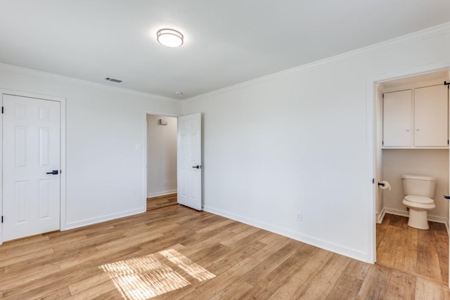 unfurnished bedroom with light hardwood / wood-style floors, ensuite bathroom, and ornamental molding