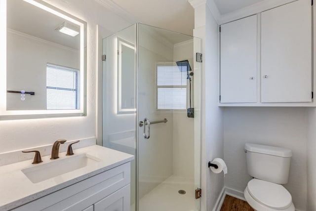 bathroom featuring toilet, hardwood / wood-style floors, crown molding, an enclosed shower, and vanity