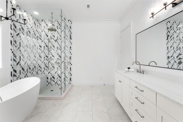 bathroom with a shower stall, ornamental molding, vanity, a freestanding bath, and marble finish floors