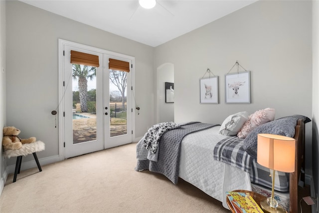 bedroom featuring light carpet, access to exterior, ceiling fan, and french doors