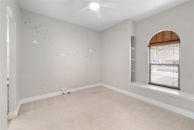 unfurnished room featuring light carpet and ceiling fan