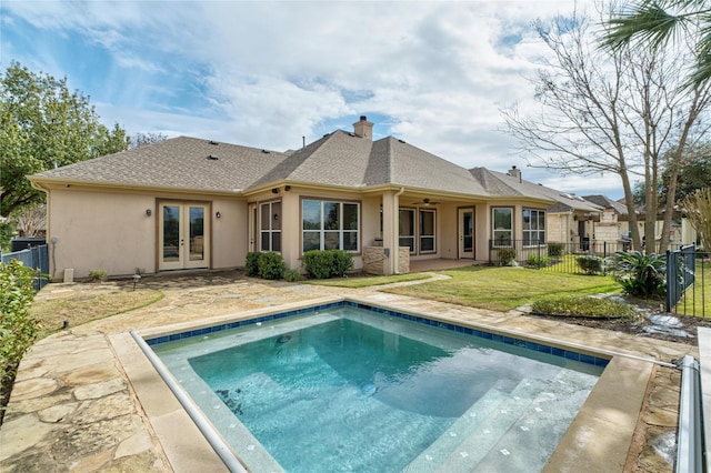 back of property with a lawn, a patio area, ceiling fan, and french doors