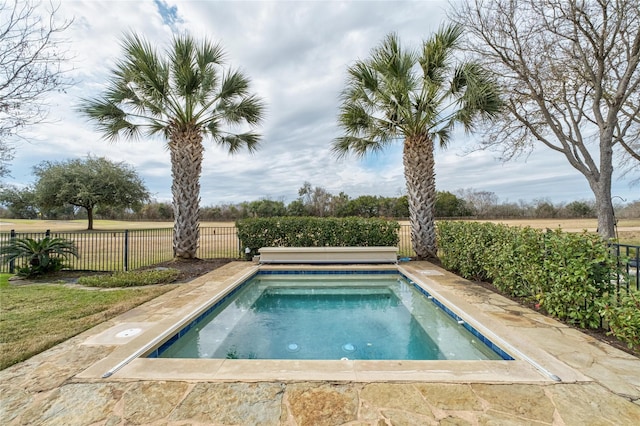 view of swimming pool featuring a rural view