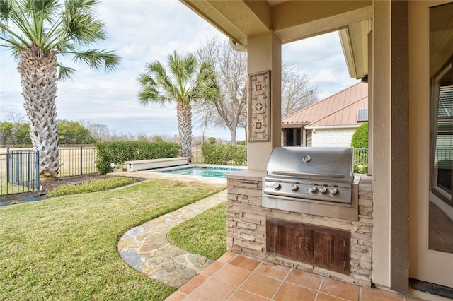 view of patio / terrace with a fenced in pool, an outdoor kitchen, and area for grilling