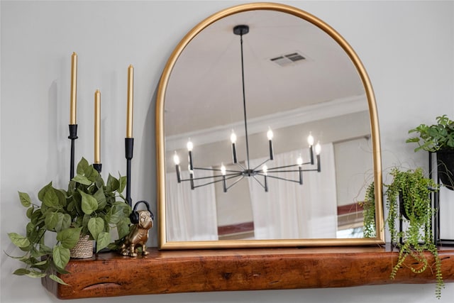 details with crown molding and a chandelier