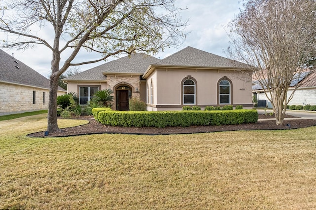 view of front of house featuring a front yard and central air condition unit