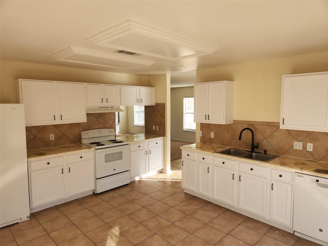 kitchen featuring white cabinets, light tile patterned floors, sink, and white appliances