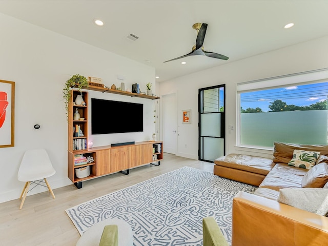 living room featuring ceiling fan and light wood-type flooring