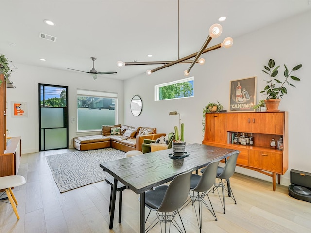 dining area with light hardwood / wood-style flooring and ceiling fan